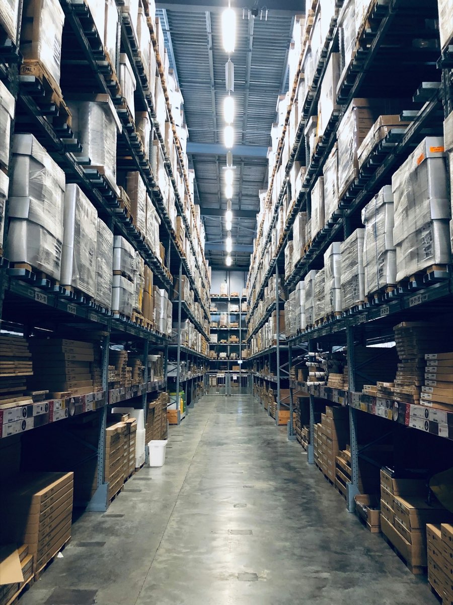 A racked warehouse aisle stacked with palletised stock
